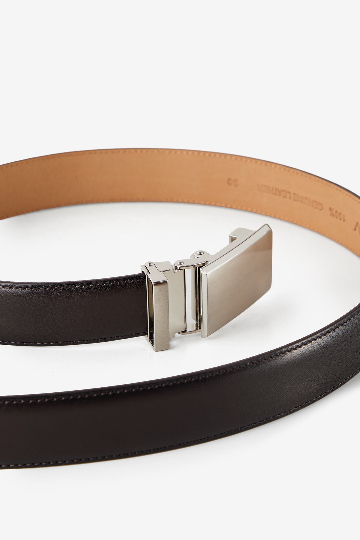 Macro crop of the brushed silver automatic buckle on a Harrow belt