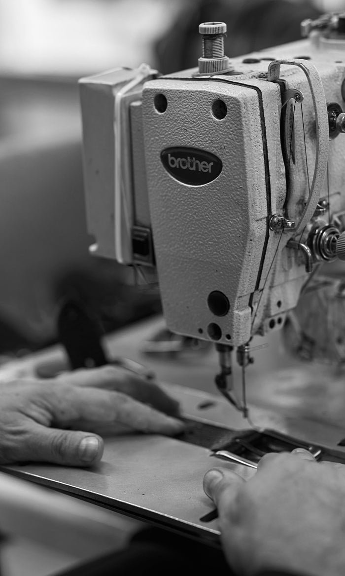 Belt strap being stitched on an industrial sewing machine in the workshop